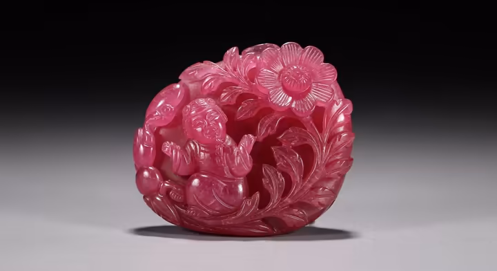 An ornate Chinese carving made from pink tourmaline, representative of pieces favored by Empress Dowager Cixi.