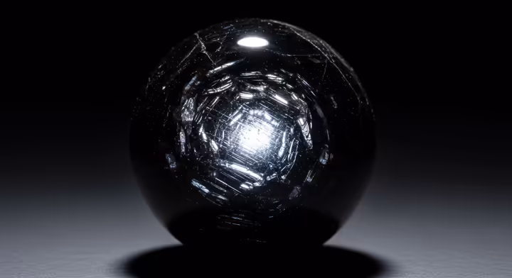 A polished sphere of silver sheen obsidian, with a bright silvery light that seems to float inside the dark stone.