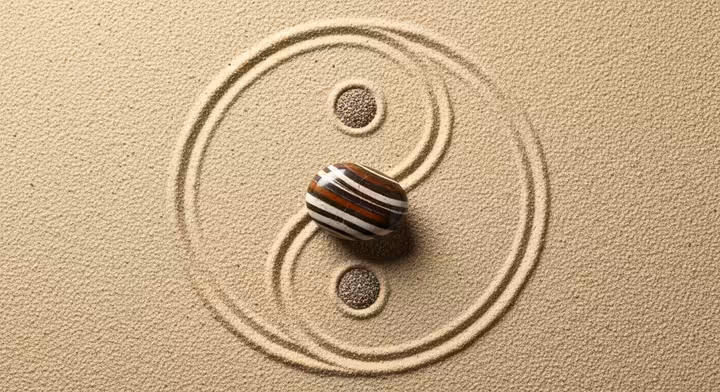 A Zebra Jasper stone placed in the center of a Yin and Yang symbol, representing balance.